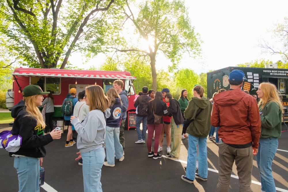 Happy crowds gather around food trucks