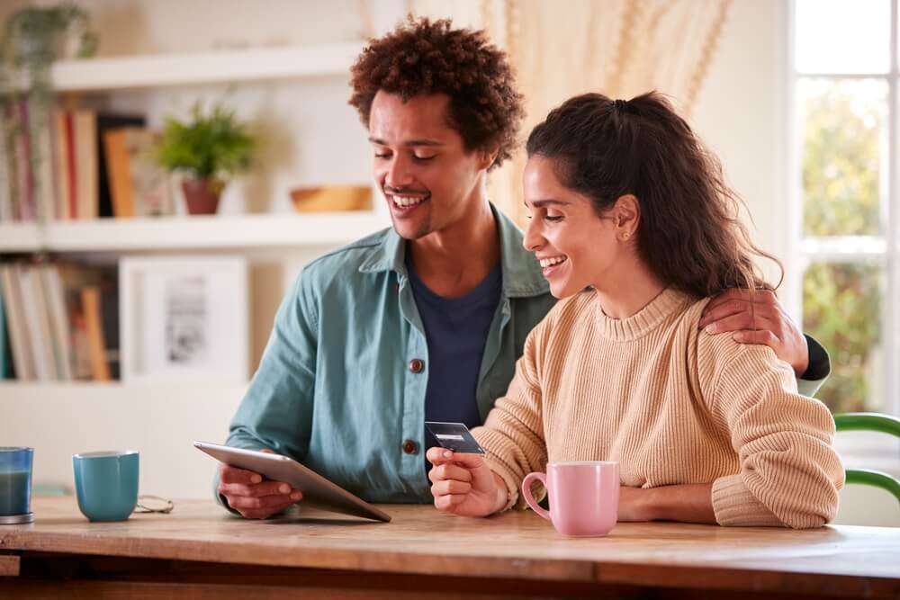 couple looking at laptop credit score