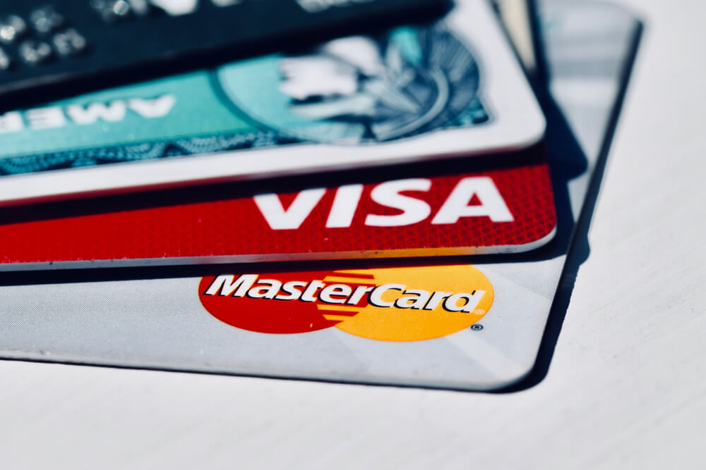 stack of different credit cards, including Visa, Mastercard and American Express. This article is an introduction to credit card tiers.