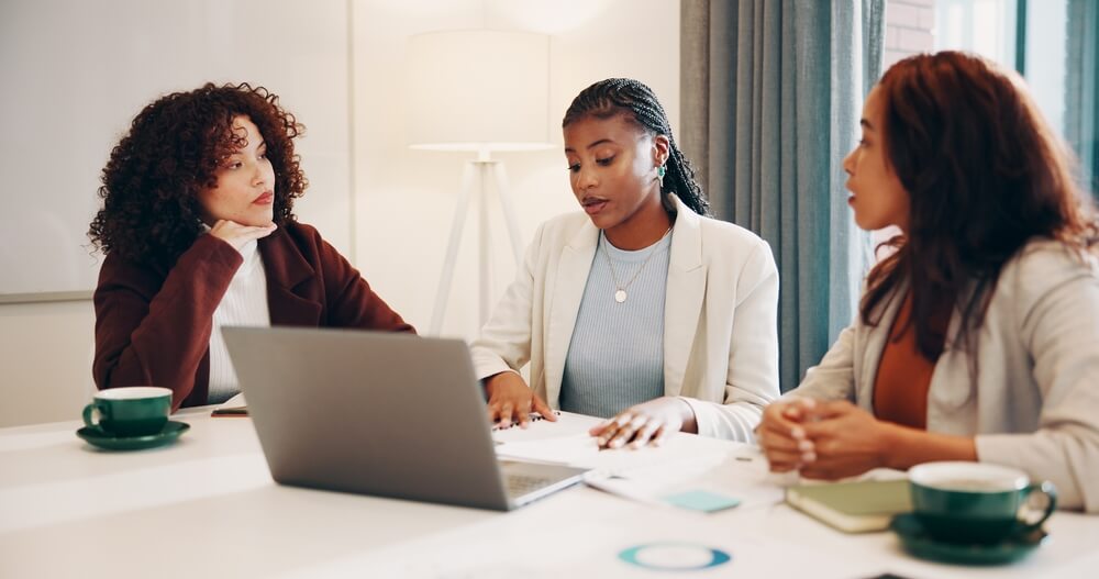 group of women entrepreneurs meeting doing taxes