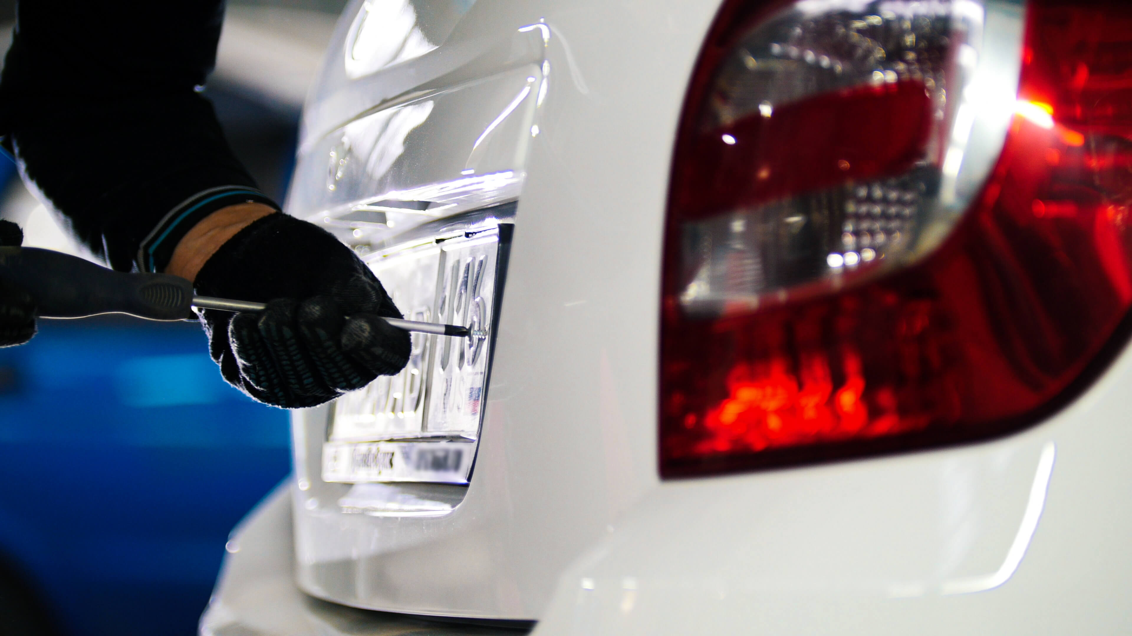 Mechanic fixing car licence plate number