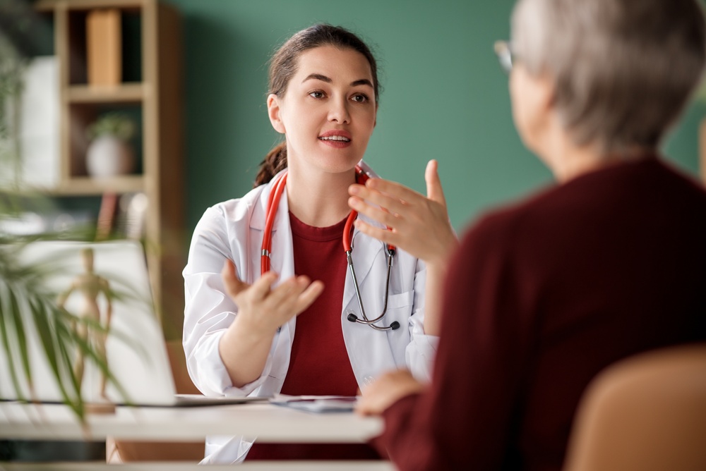 Female patient listening to a doctor in hospital