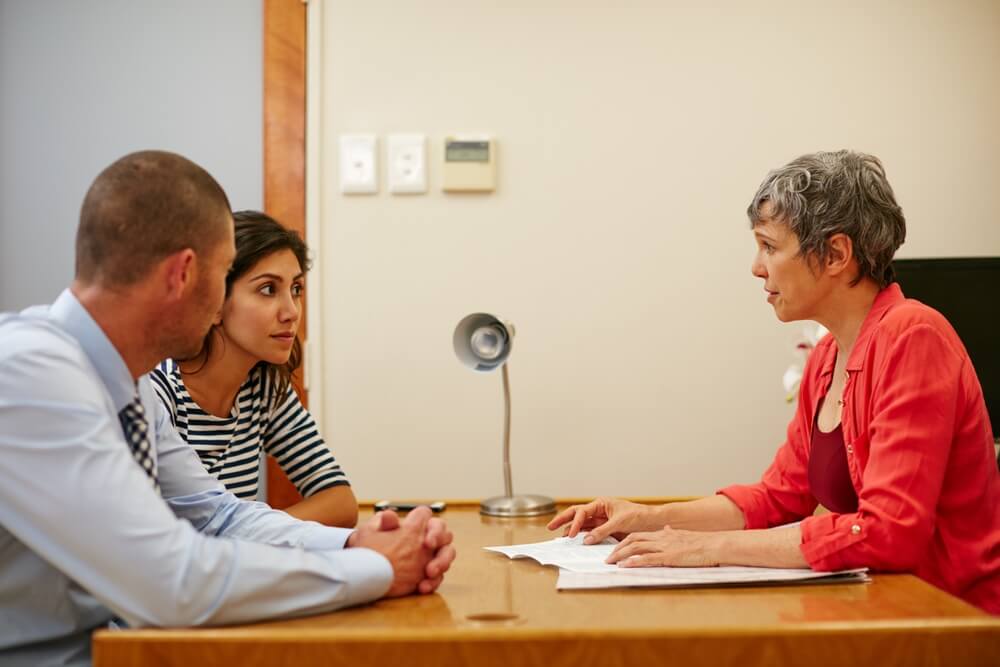Financial consultant, documents and woman with couple in office for budget planning, advice and investment