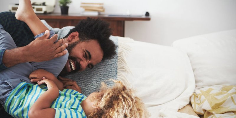 A dad playing with his cute kid