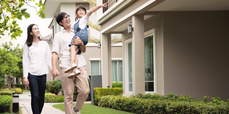 A family walk on the sidewalk together