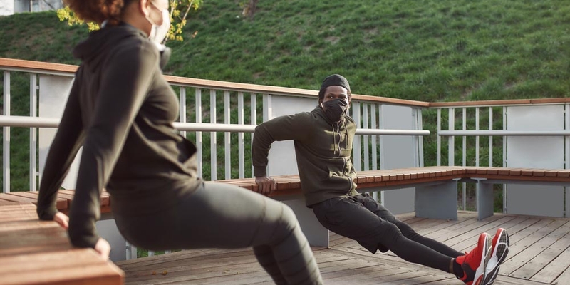 Two people working out, doing push ups