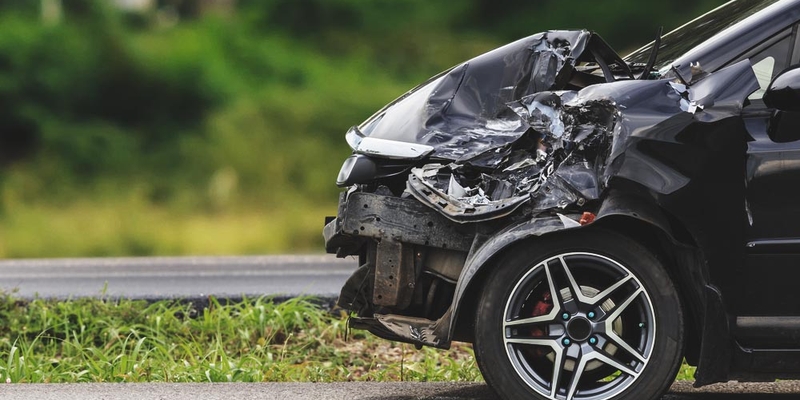 A vehicle's front-end is completely crumpled and damaged after a collision/car accident