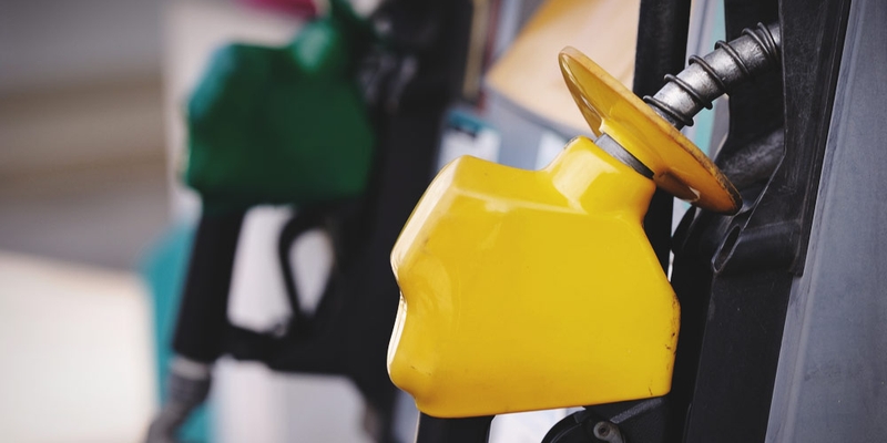 A close up of a yellow gas nozzle