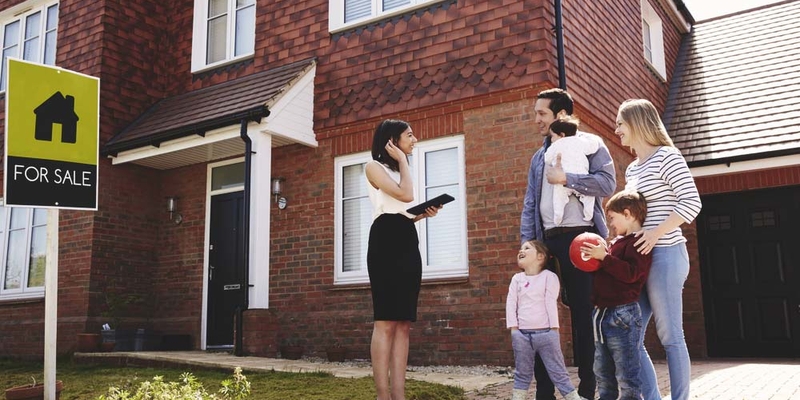 family looking at house for sale with real estate agent.jpg
