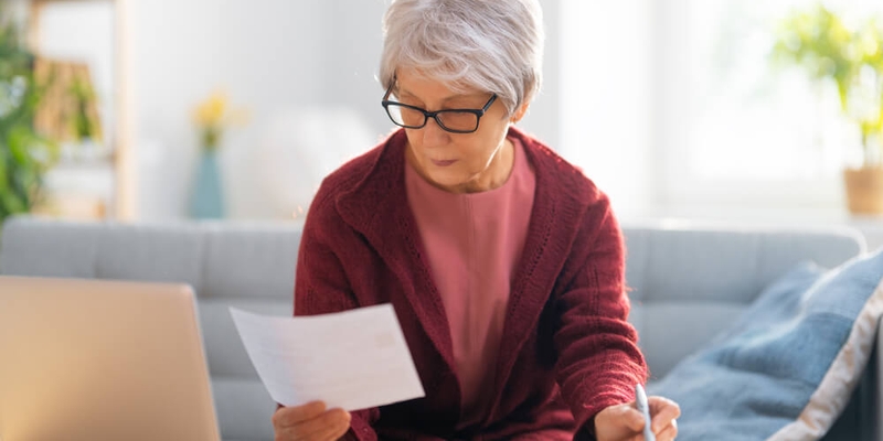 older woman scanning document_what are real estate commissions in Canada.jpg