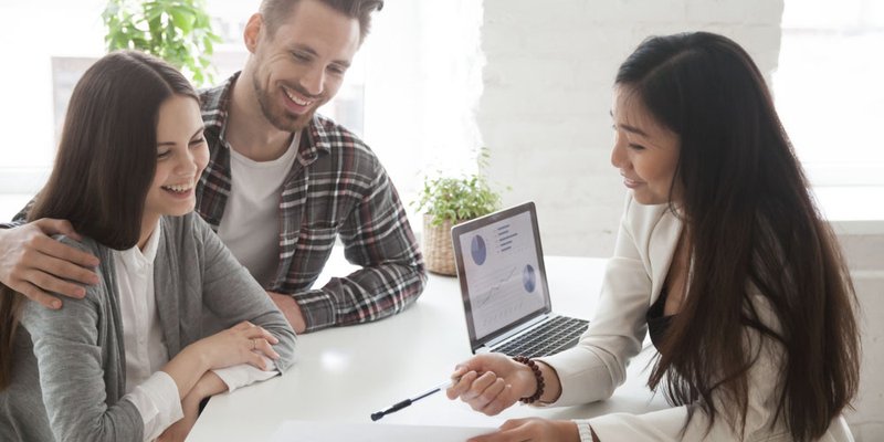 A young couple speaking with a financial advisor