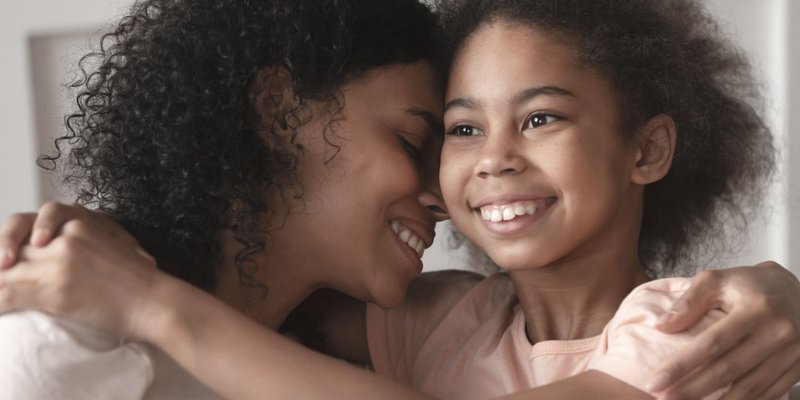 A mother hugs her daughter