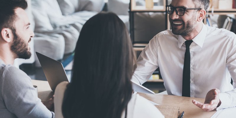 A couple listen to the advice of a mortgage broker