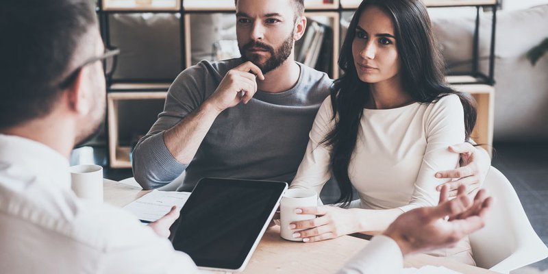 A young couple listen to a mortgage broker about their options