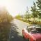 older retired couple in a red convertible driving near a vineyard_mandatory minimum car insurance in Canada