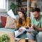 young couple looking confused at auto insurance document