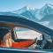 woman driving through snow landscape