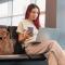 Asian woman freelancer with coffee and laptop working at an airport gate