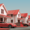 Sequence of residential homes with electric cars in driveway
