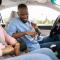man and woman putting seatbelts in car
