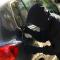Thief with screwdriver opening fuel cap. Car hijacking