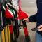 Credit card held near petrol pump during car refueling