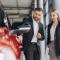 Car Sales Manager Showing Red Car To Woman