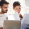 A couple look concerned as they work through paperwork