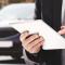 man with iPad and car in the background