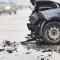 A black car with front-end damage after a collision