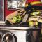 Bunker gear and helmet resting on a fire truck's bumper