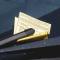 A parking ticket is tucked under a windshield wiper