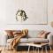 modern home interior shows a closeup of a kitchen table with a vase of eucalyptus on it
