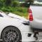 A white car rear-ends a pickup truck in a collision/car accident, and is damaged