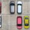 An aerial view of brightly coloured cars in a parking lot