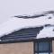 roof with snow on the shingles in the winter