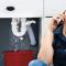 Woman with plumbing issues next to a red bucket_on the phone with landlord.jpg