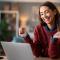 girl in swetaer looking at laptop with creidt card in hand (1).jpg
