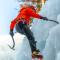 man with climbing equipment, ice axes and rope, hiking at a frozen waterfall (1).jpg