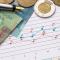 Canadian money spread out around a graph and a calculator