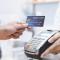 A person taps their credit card to pay at a store