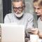 An older couple calculate their expenses together at the table