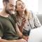 A couple laugh together as they shop online