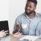 A couple sits with coffee mugs and speaks with a mortgage broker or financial advisor