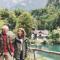 An older couple walk around a scenic lake