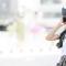A young woman wearing a big floppy hat talks on the phone