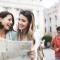 Two women laugh and look at a map together