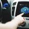 A person uses the touch screen in a car to see the eco settings