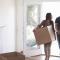 A young couple moving boxes into their new home