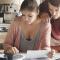 A man and a woman calculate their bills together